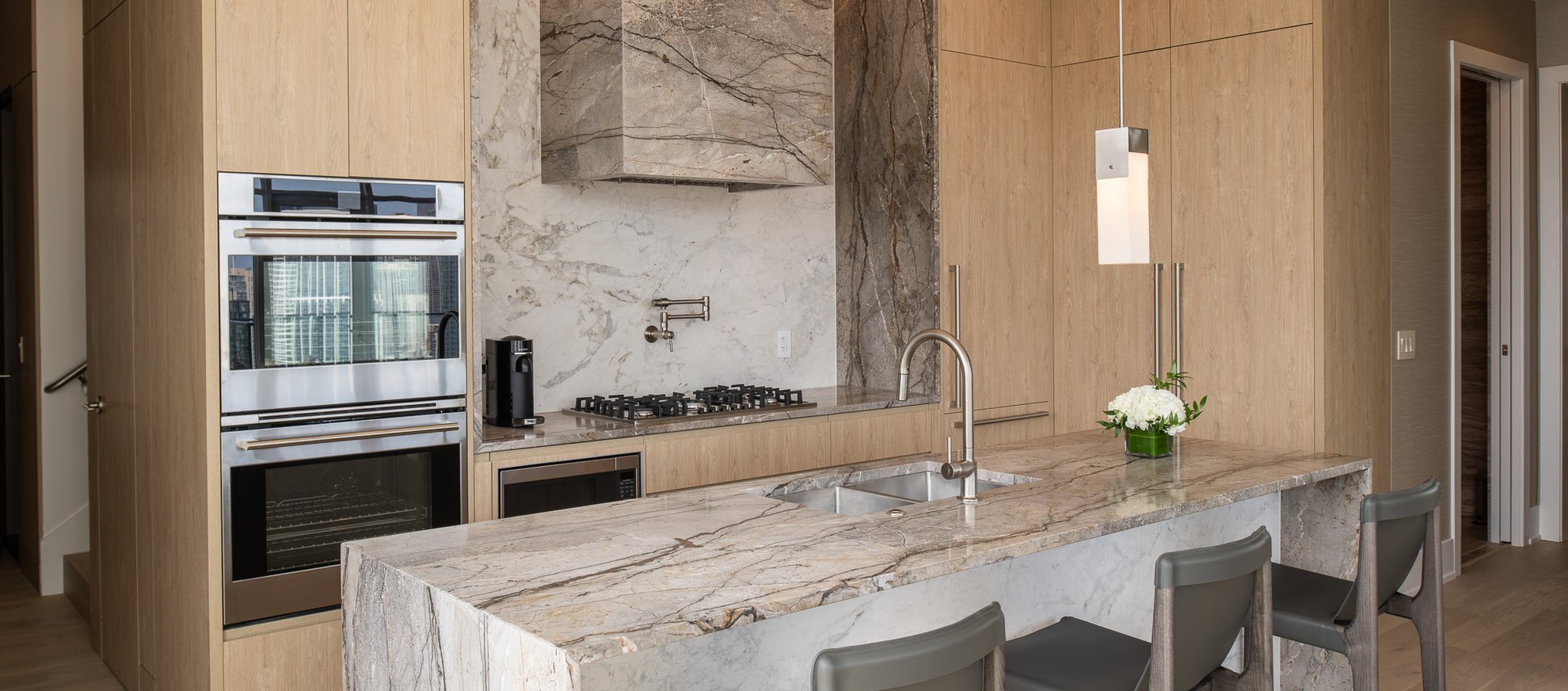 kitchen area with kitchen island and premium appliances at the penthouse level chicago fulton market