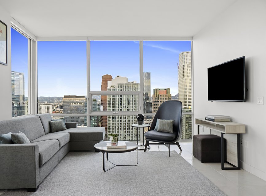 living room with a view of the LA skyline in a two bedroom suite at Level Los Angeles South Olive