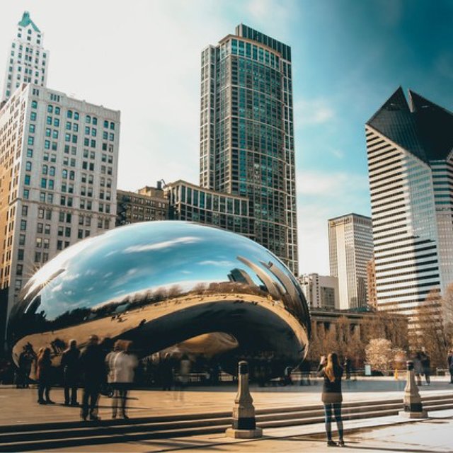 tourists taking photos of chicago bean in downtown chicago