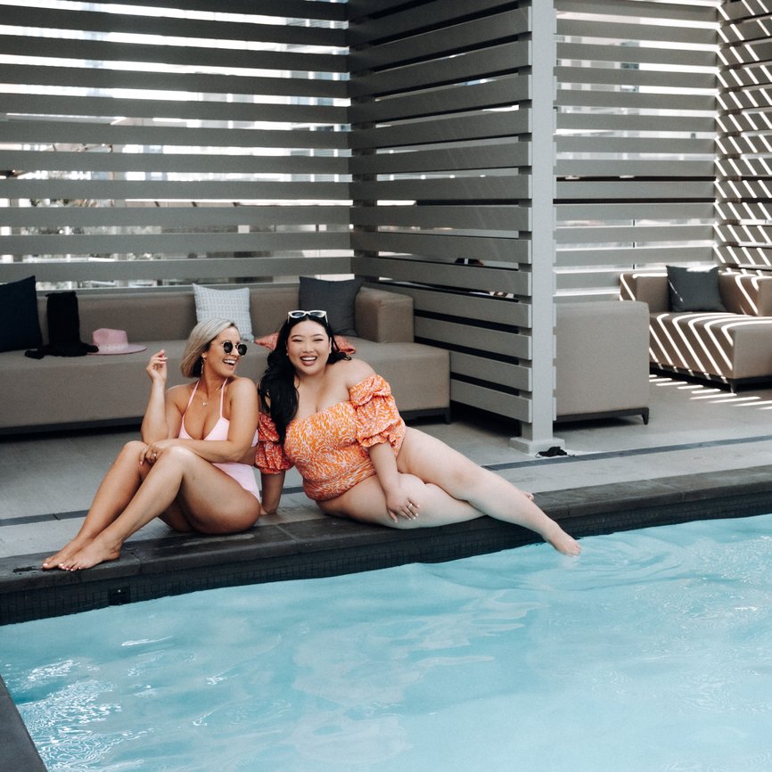 two girls enjoy the outdoor pool at level seattle south lake union