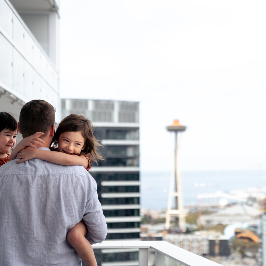 father holding daughters at level seattle south lake union