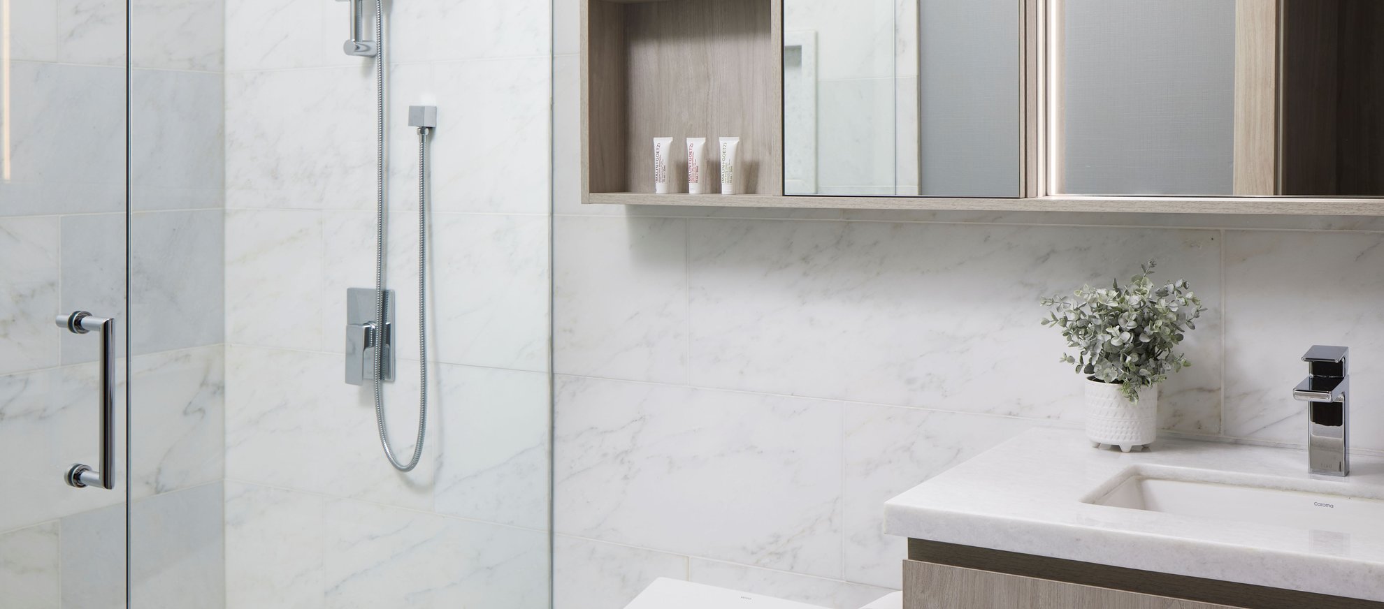 modern bathroom level seattle south lake union penthouse features large vanity mirror, wooden cabinets and glass door walk in shower.jpg