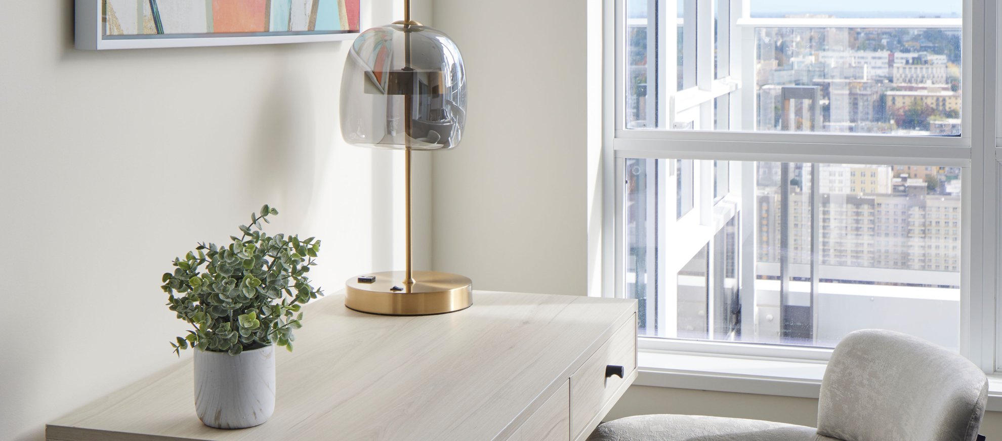 modern office setting with a large window for natural light at level seattle south lake union the penthouse with space needle city view.jpg